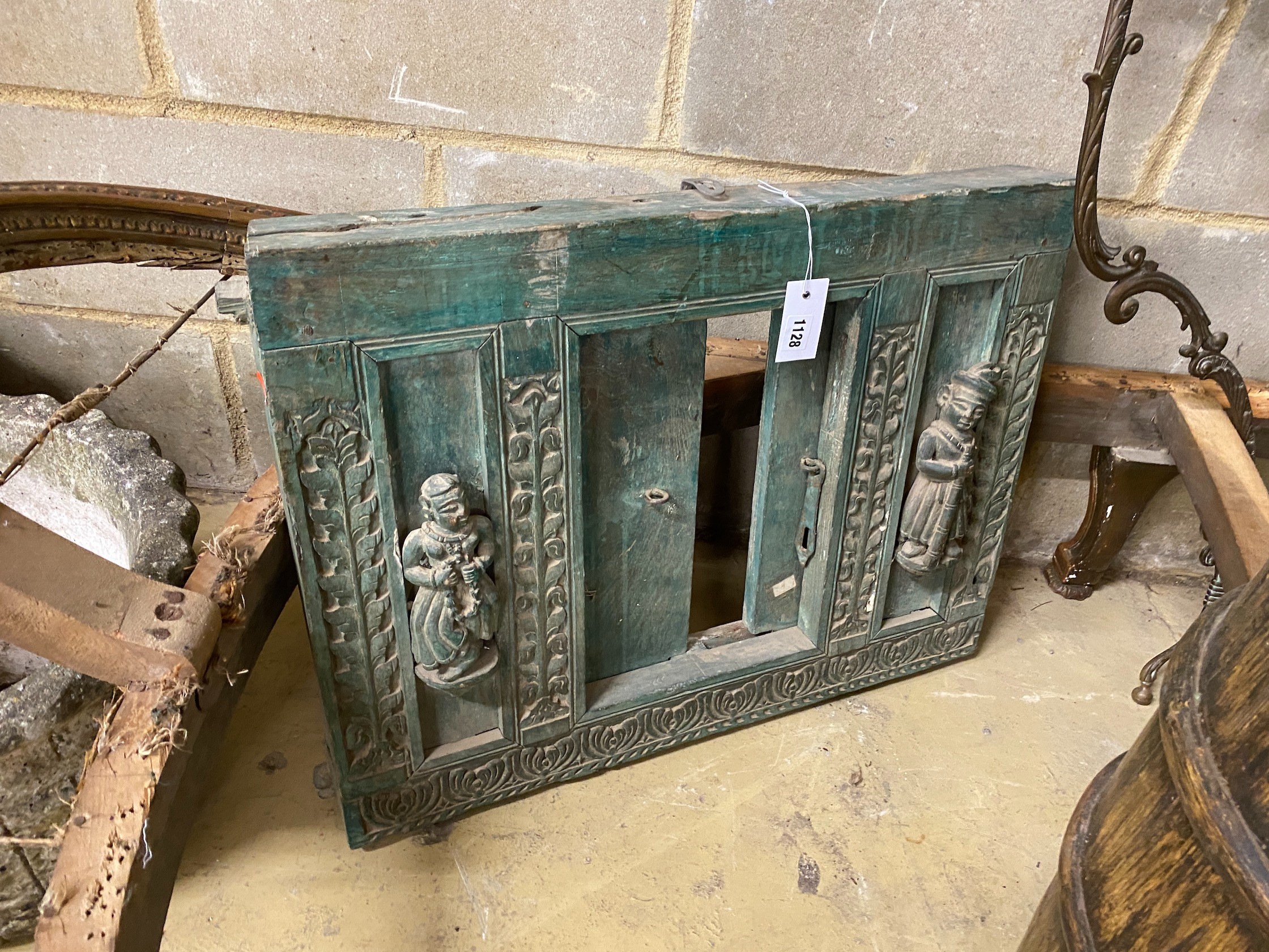An Indonesian painted carved wood hatch, width 67cm, height 52cm and a faux wood stick stand